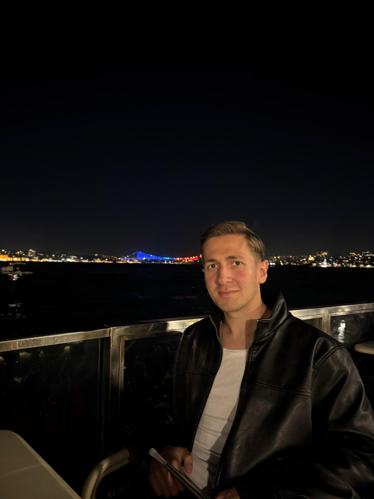 Portrait of Onuralp Turgut overlooking Istanbul at night